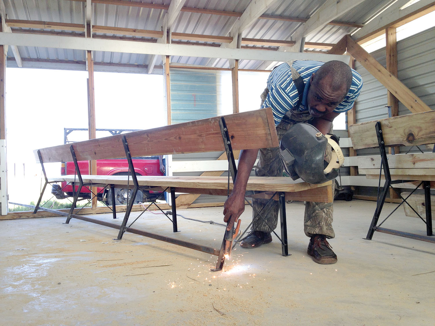 Luc Bertrand, a graduate of New Missions from Neply, Haiti, is our welder who makes the legs for our church benches.
