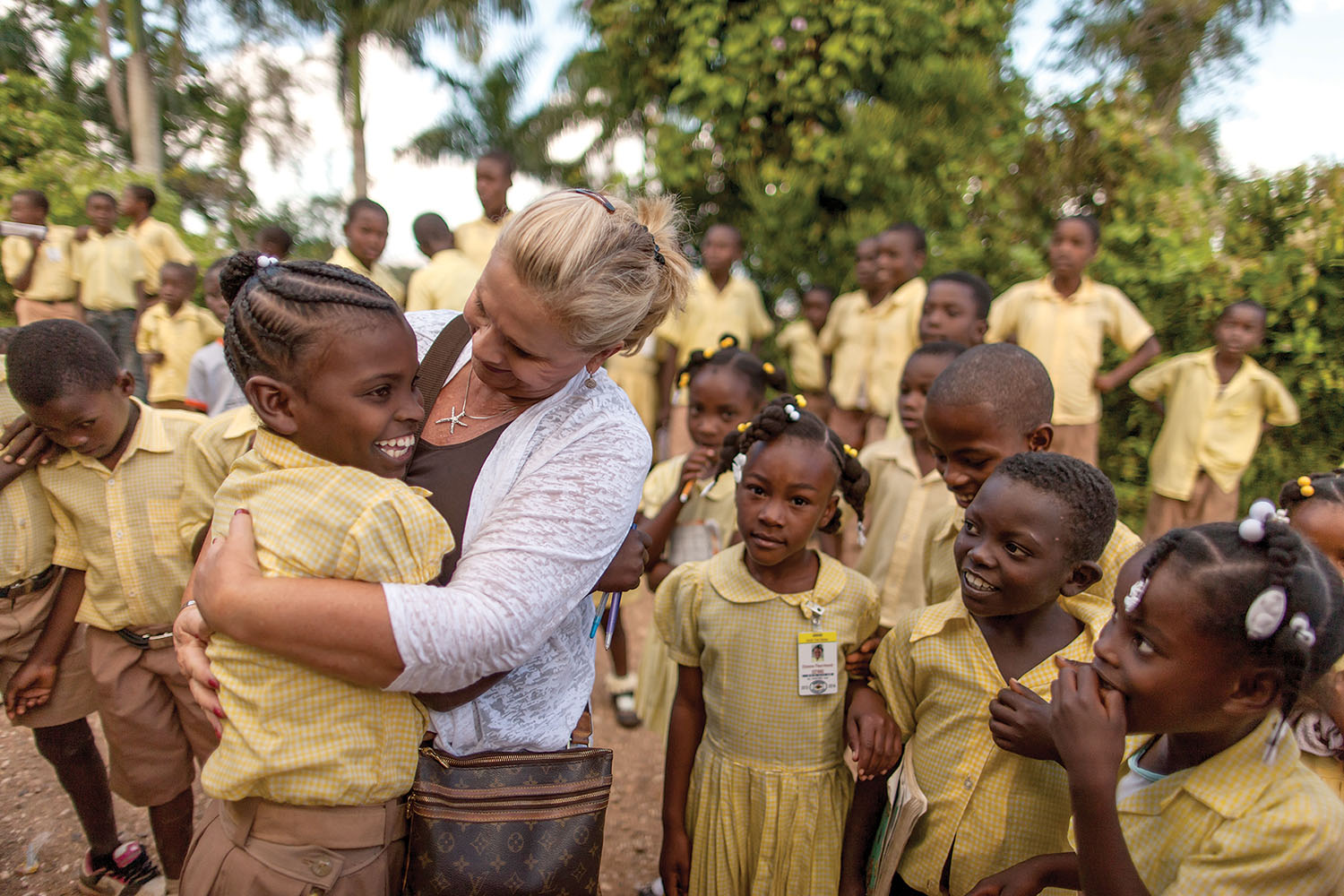 Janet Hunt and her sponsored child Rose embrace with joy as they are reunited at our school in Tom Gateau.