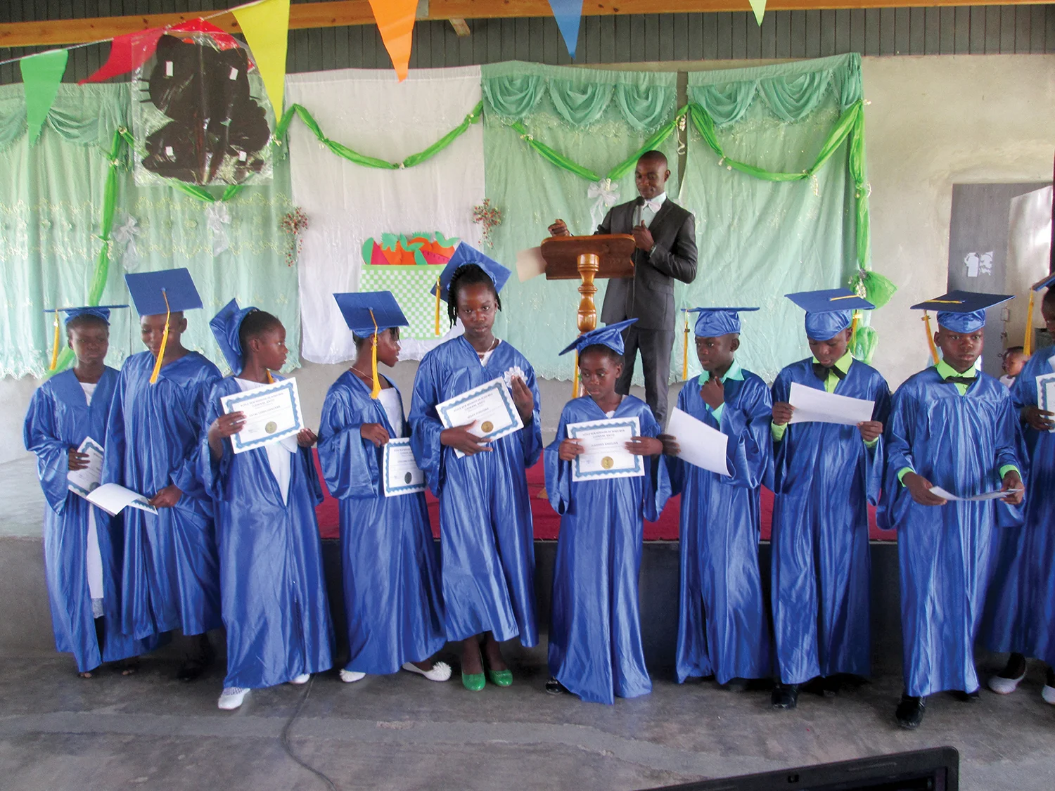 Pastor Yaguel, graduate from the class of 2005, celebrates sixth graders reaching the milestone of graduating primary school in Haiti.