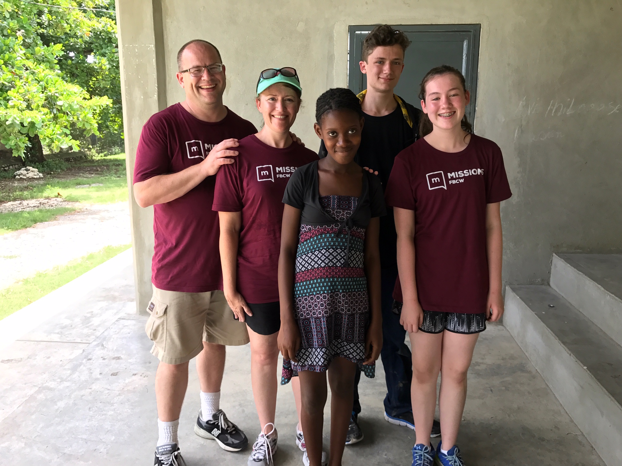 The Taggart family with their sponsor child, Berline.