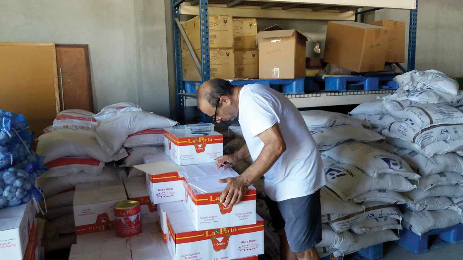 Charlie DeTellis reviews the inventory of a food delivery, where monthly nearly $30,000 is spent on food.