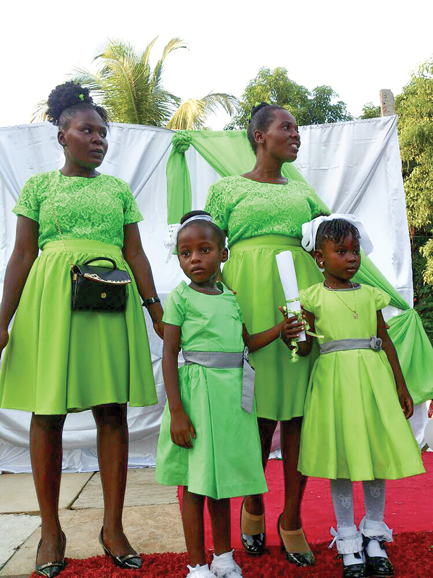 Mothers stand proud with their young children being promoted to their next grade level at our school in Bossier, Haiti.