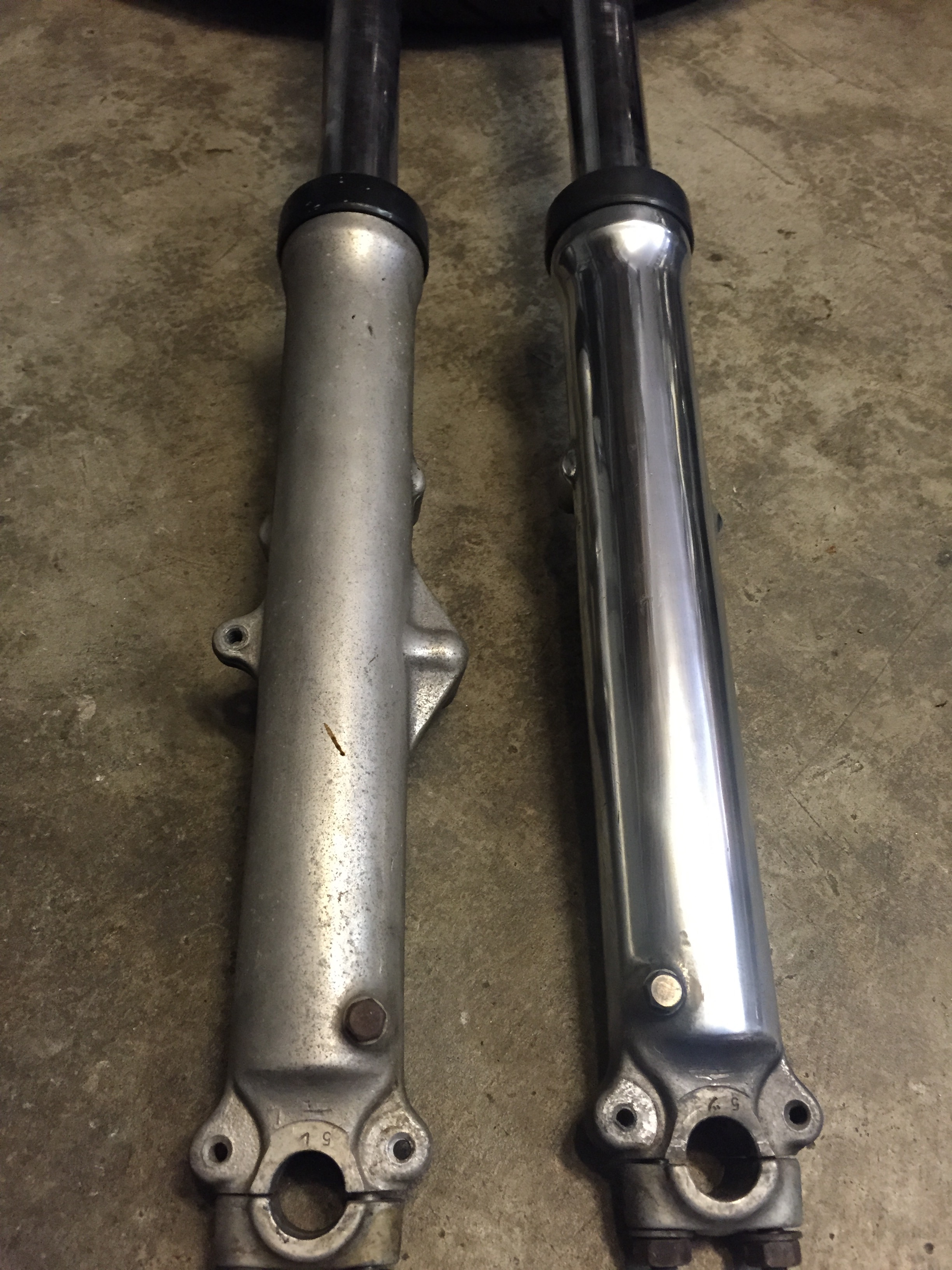 This model CB750 only has a single disc on the front. We shaved the unused mounts and polished the fork lowers. The before and after is rewarding.