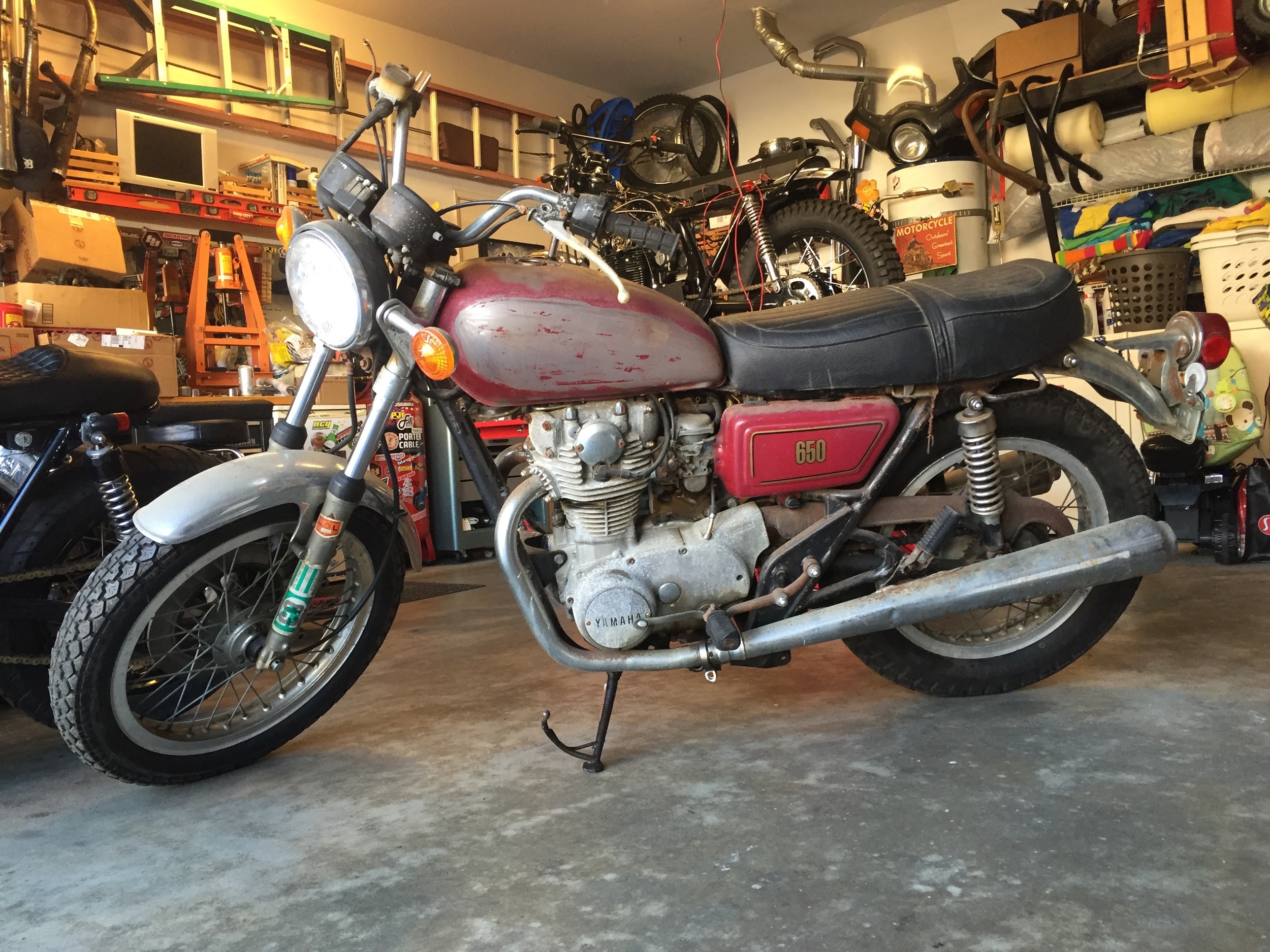 The "Before" shot. Pretty bone stock but ugly. The previous owner had plans to make a legit flat tracker out of it. With the bike came a box of brand new goodies including carb and petcock rebuild kits, a new key switch, and even a Radian swingarm.