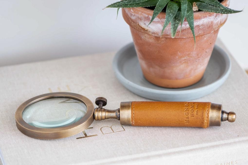 Forget about a utilitarian magnifying glass—gift them this leather-handled, aged-brass one that adds sophisticated charm to their work space. 