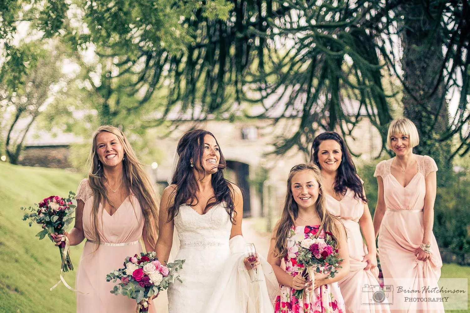 Bride and bridemmaids have some fun walking from wedding at Ballybeg House