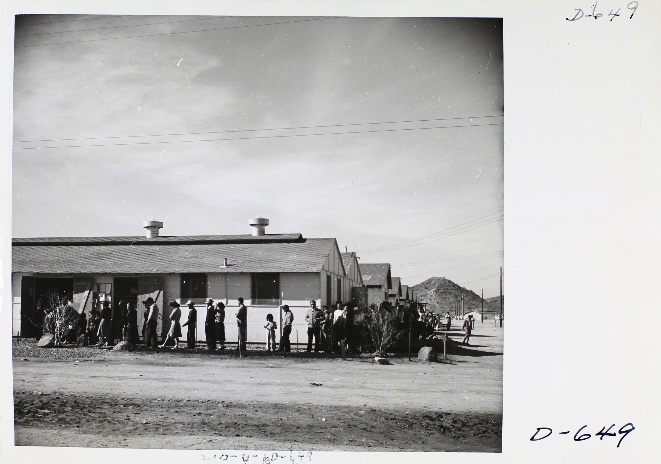 Gila River residents wait for lunch outside the mess hall, 1942.
