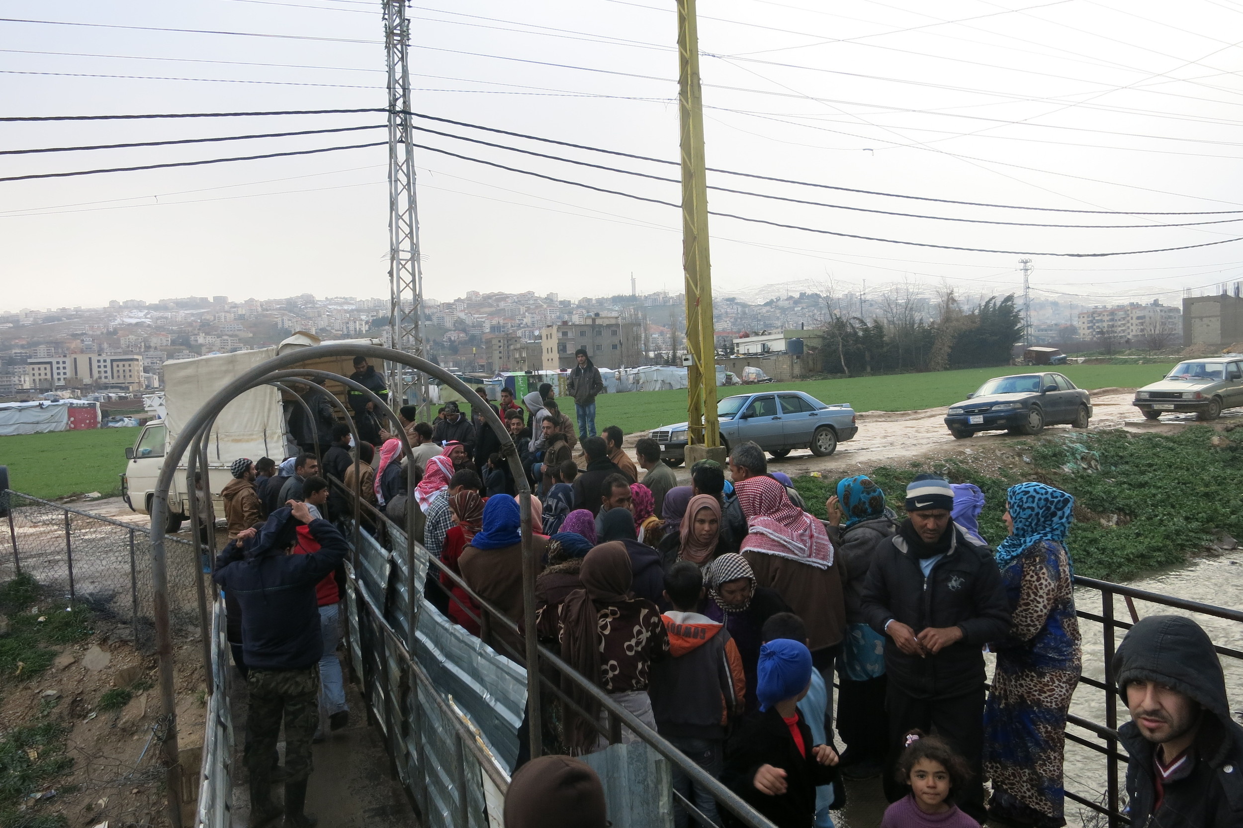 Refugees line up in Lebanon to receive packages full of life saving aid.