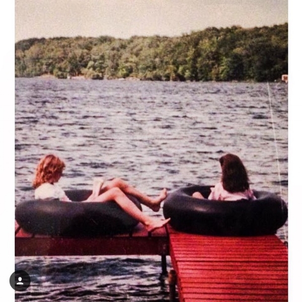 My cousin and I reading on the dock at the cabin. 