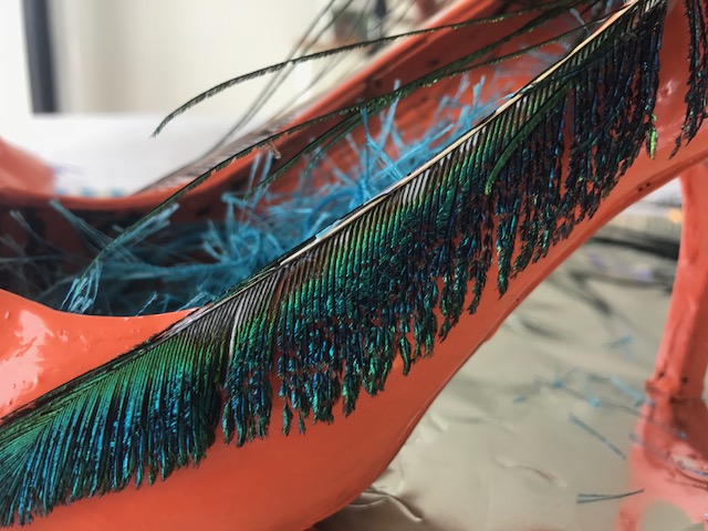 I started by gluing peacock feathers on the sides of shoes.
