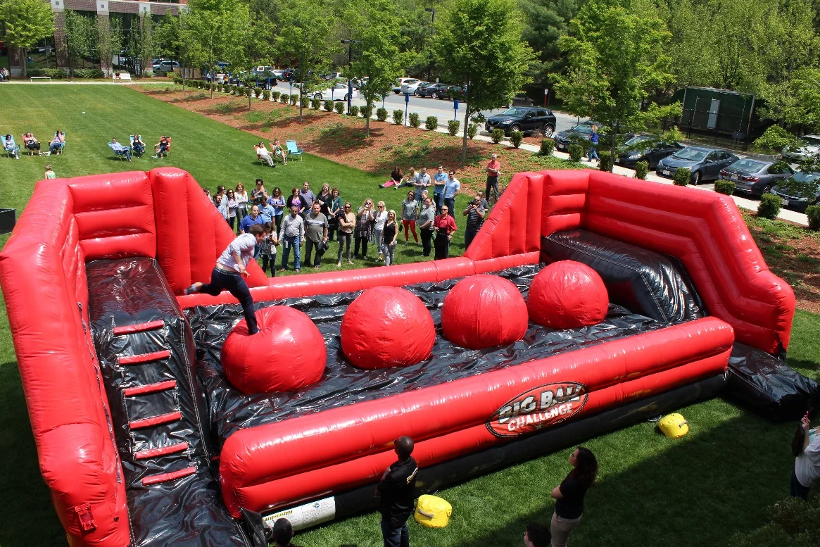 Have you ever wanted to try your Ninja or Leap frog skills? With the Leaps and Bounds interactive course you're going to get your chance. This game features a series of 4 giant inflatable balls which challengers must leap across to reach the other side. Try to cross the course by leaping from ball to ball like a frog or running across the giant balls to make it to the other side without falling. But don't worry if you fall off, the floor of the pit is protected by a super soft-landing cushion with patented air bag technology. Ask about theme-ing Leaps and Bounds to fit your next sports event. We can change out the balls to reflect the sports theme of your choice. All baseballs or all basketballs. People Per Hour: 100+ Power Requirement: (2) 20 AMP Set-up Time: 1 Hour Space Required: 39’ X 21’ X 12’