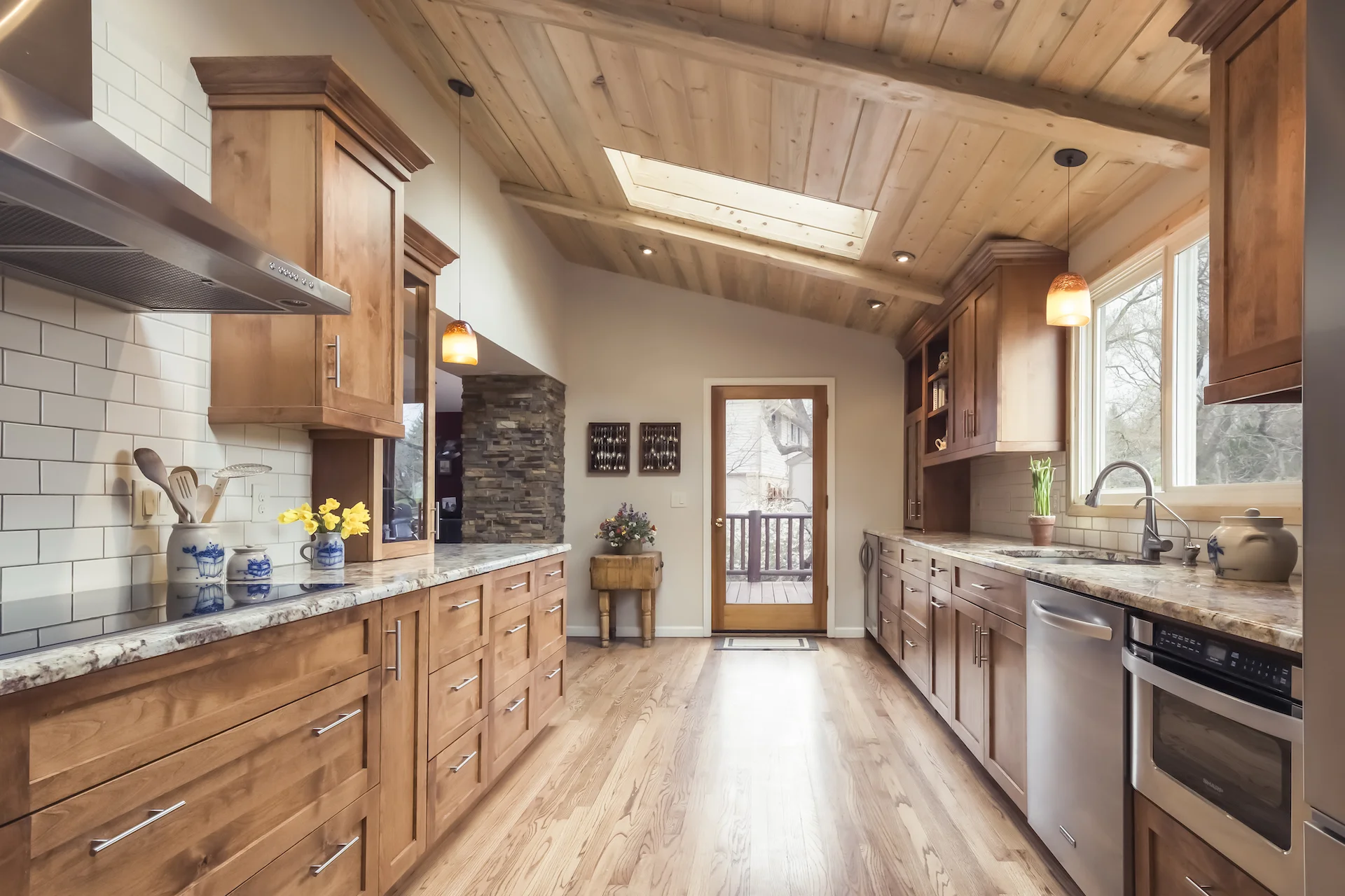 We exposed the shed roof on this galley kitchen and highlighted it with beetle kill pine planks. &nbsp;