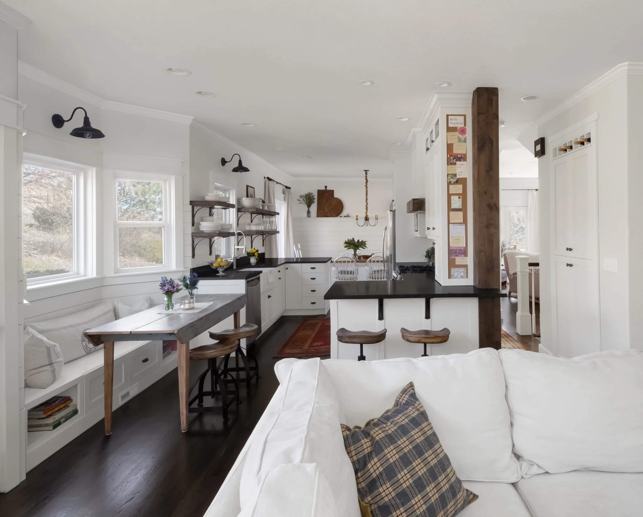 We took out two walls at each end of this kitchen, removed a dropped soffit that ran the perimeter of the kitchen, added a window seat, and transformed an odd hall closet into a really useful pantry with wine storage at the top, in addition to quite…