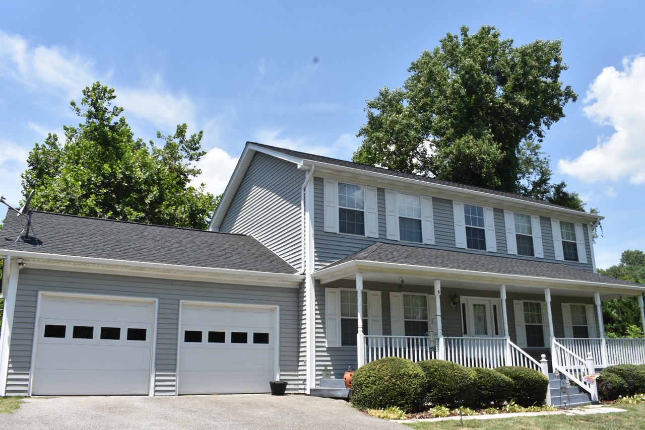 A beautiful home with a new roof under blue skies and bright sun!