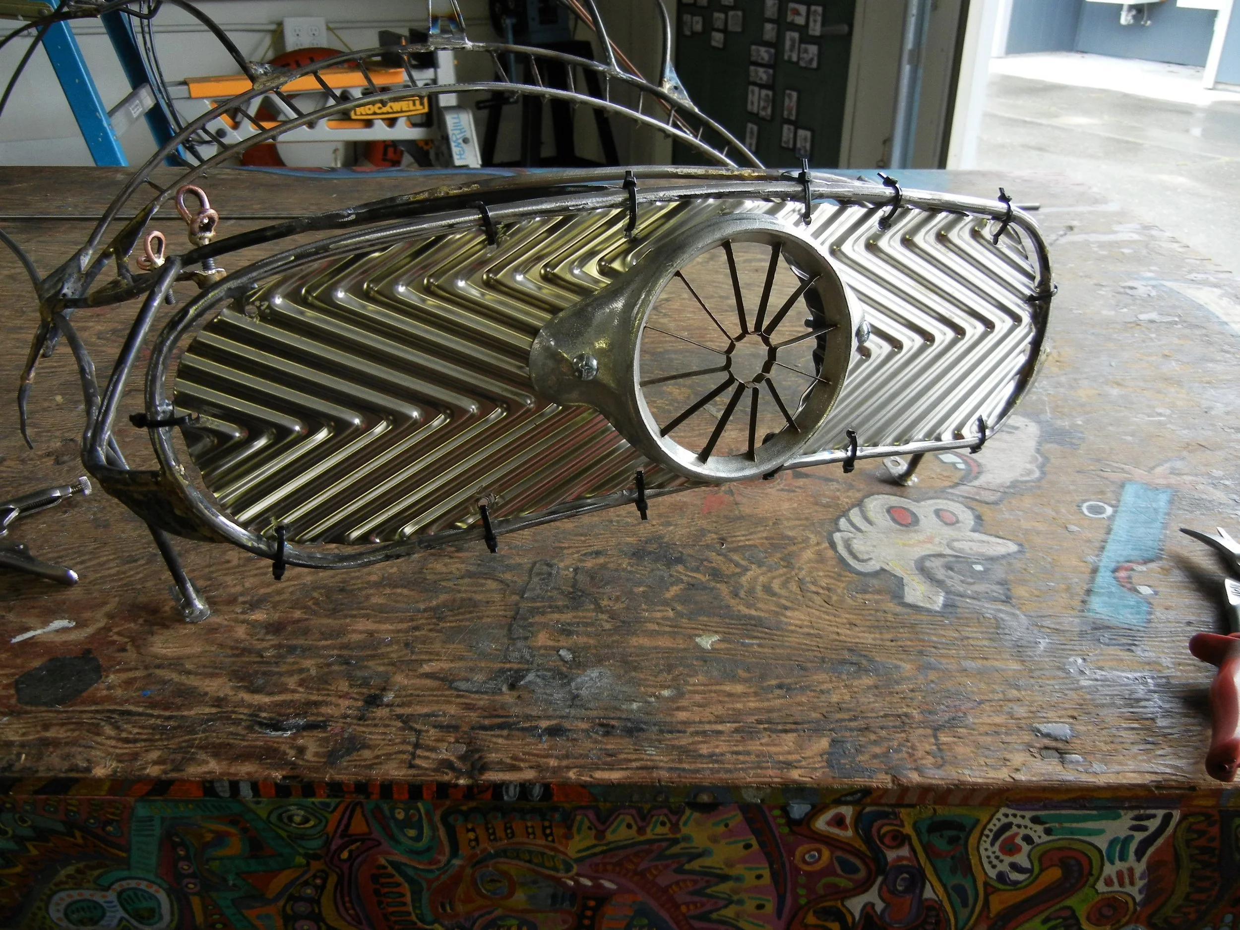  Grill mounted temporaily with the zip tie later to be followed up with rivets. Air vent is an old apple corer found in amoungst engine parts and makes the perfect addition to this ride. 