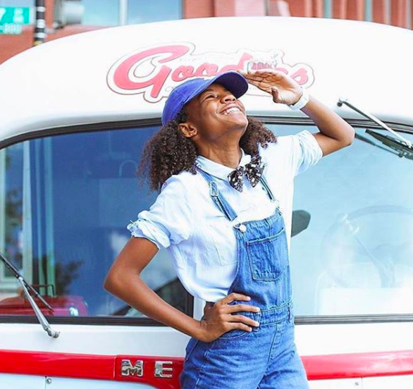 A young customer posing in front of the Goodies food truck in Washington DC.