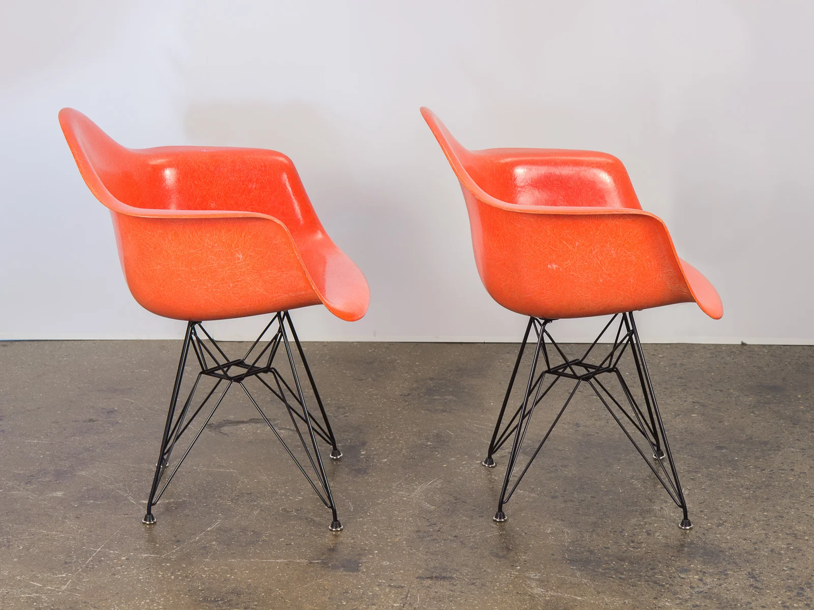 open_air_modern_pair_of_orange_eames_fiberglass_armchairs_for_herman_miller_on_black_eiffel_base-4.jpg