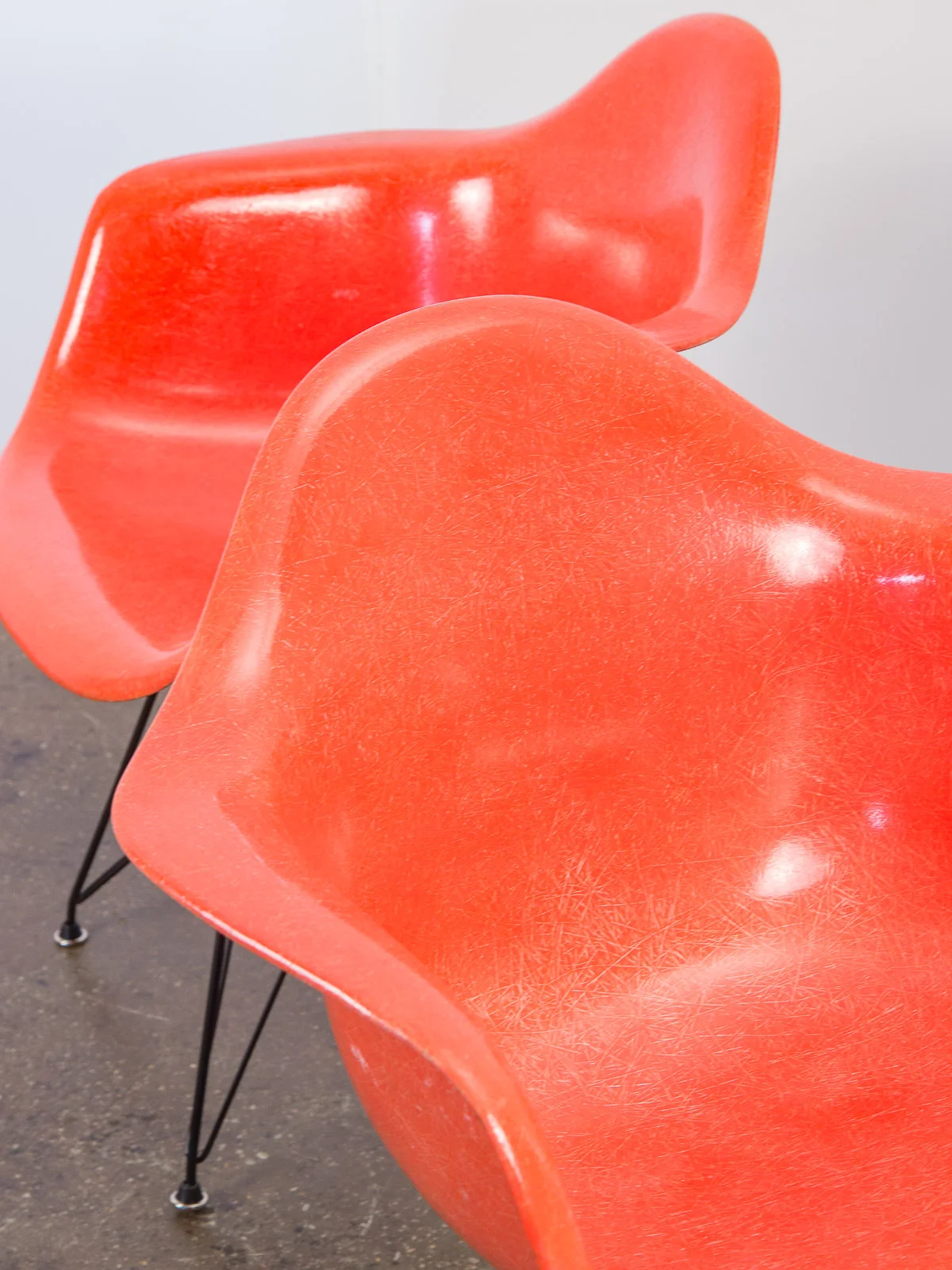 open_air_modern_pair_of_orange_eames_fiberglass_armchairs_for_herman_miller_on_black_eiffel_base-6.jpg