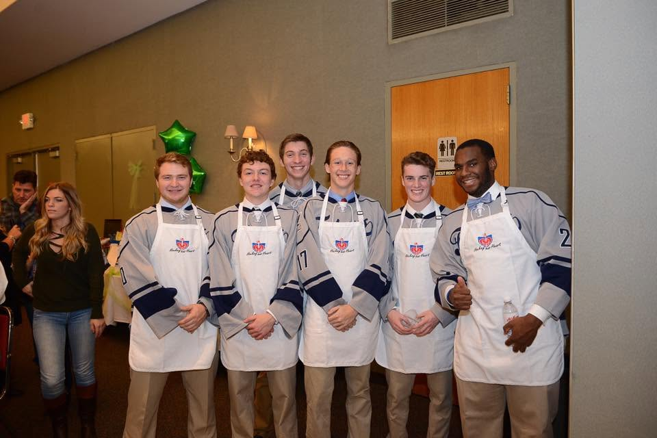 Hockey players volunteering at a Hockey has Heart community event