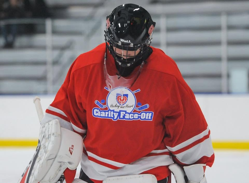 Goalie wearing a red Hockey has Heart Charity Face-Off jersey
