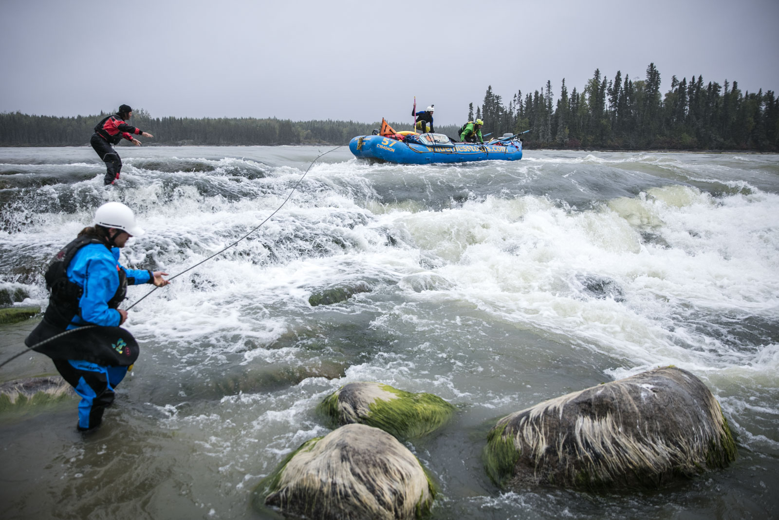  Hal Monkman tosses the rope to Ben Marr who prepares to anchor the raft as it is lined around potentially dangerous holes at Eve's Falls. Photo/David Jackson 