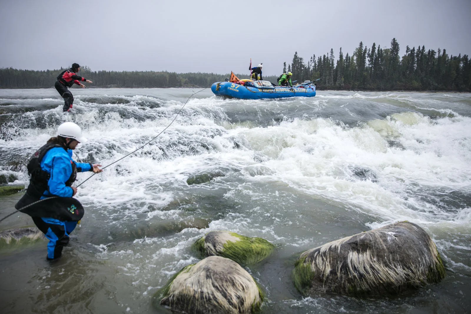 Hal Monkman tosses the rope to Ben Marr who prepares to anchor the raft as it is lined around potentially dangerous holes at Eve's Falls. Photo/David Jackson