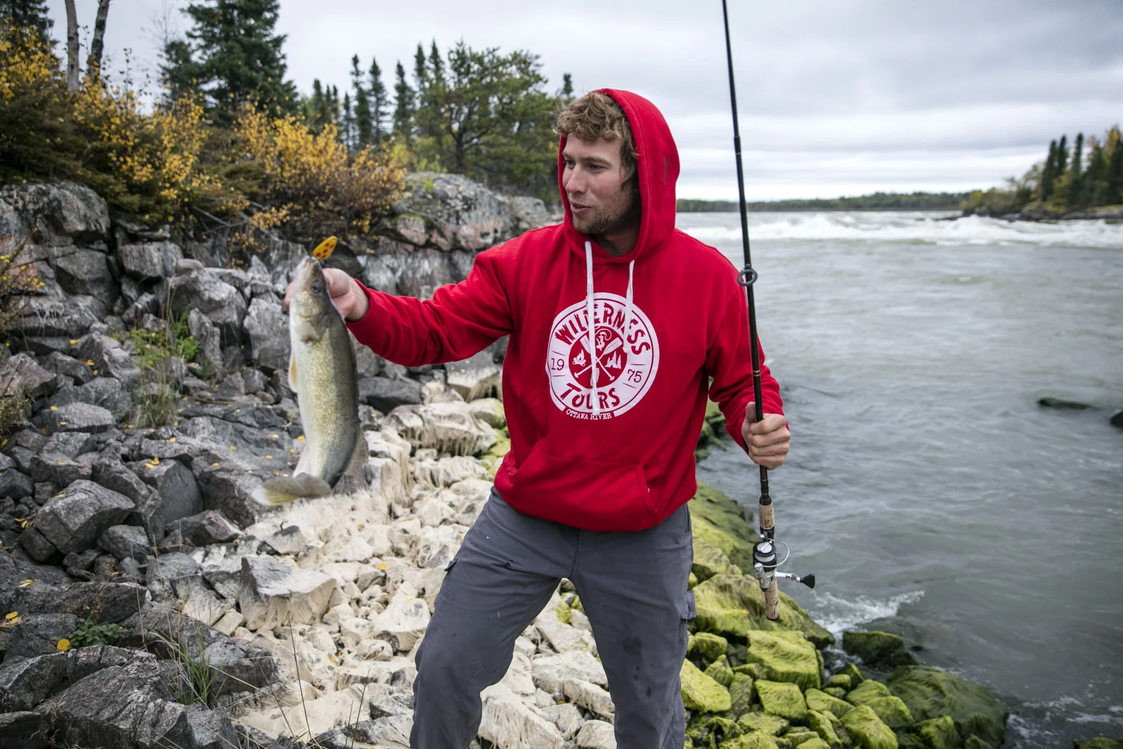 Joel Kowalski pulls a walleye from below Bladder Falls at basecamp. Photo/David Jackson