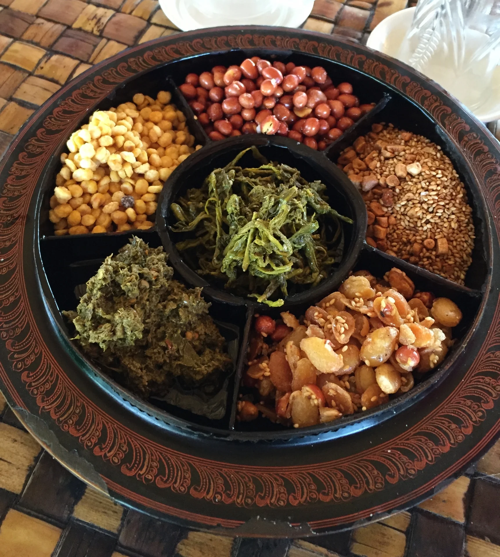 Most meals in Myanmar begin with this snack tray. In it there are nuts, legumes, and fermented tea leaves...I like to mix them together to make a sort of chex mix salad. One of the things I miss most about Myanmar are the salads. The curries they served were mild but greasy. The salads were a mixture of greens (mostly shredded green papaya) nuts, and other herbs. 