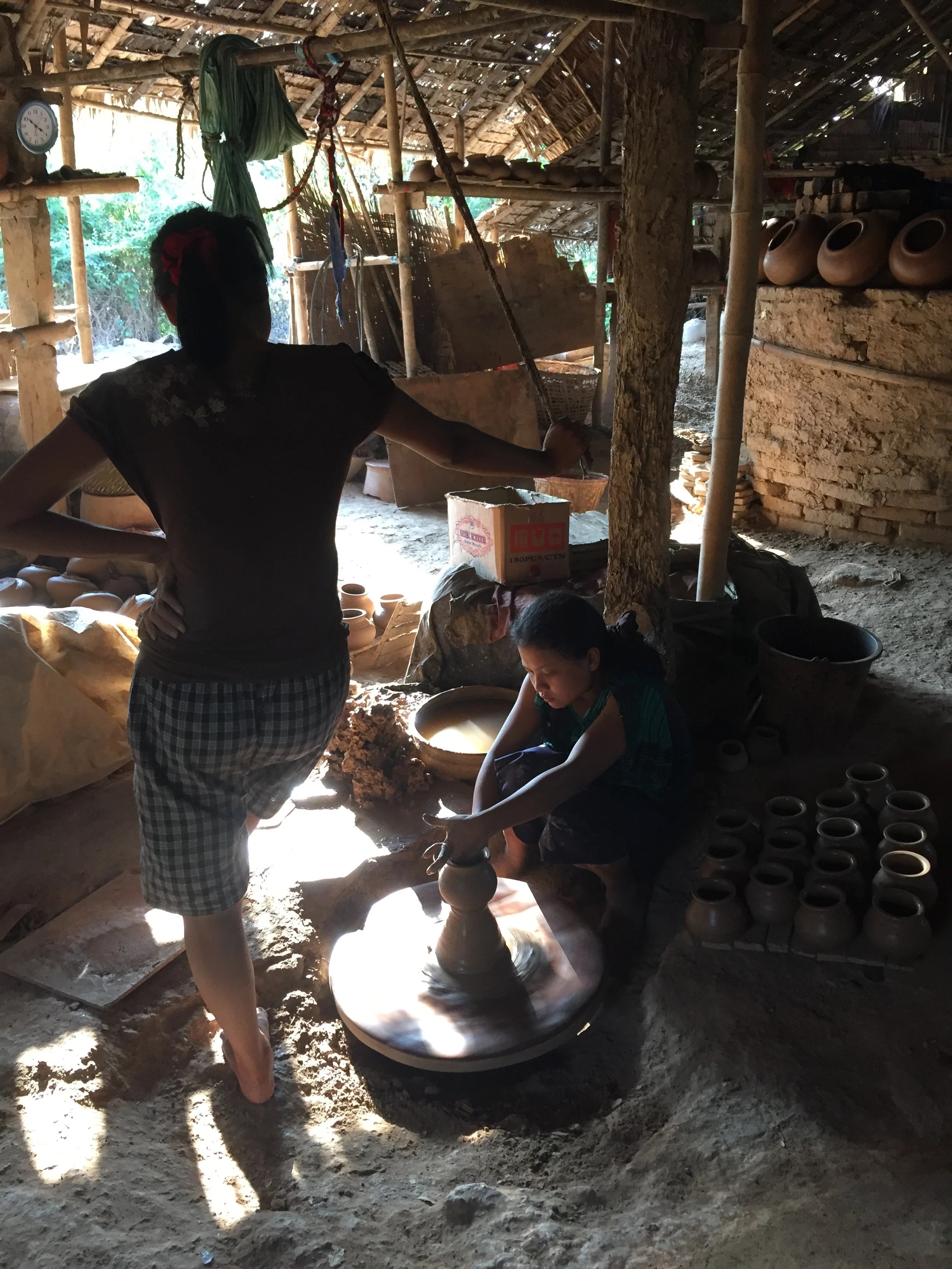 Potters in their workshop in the village of Twante. 