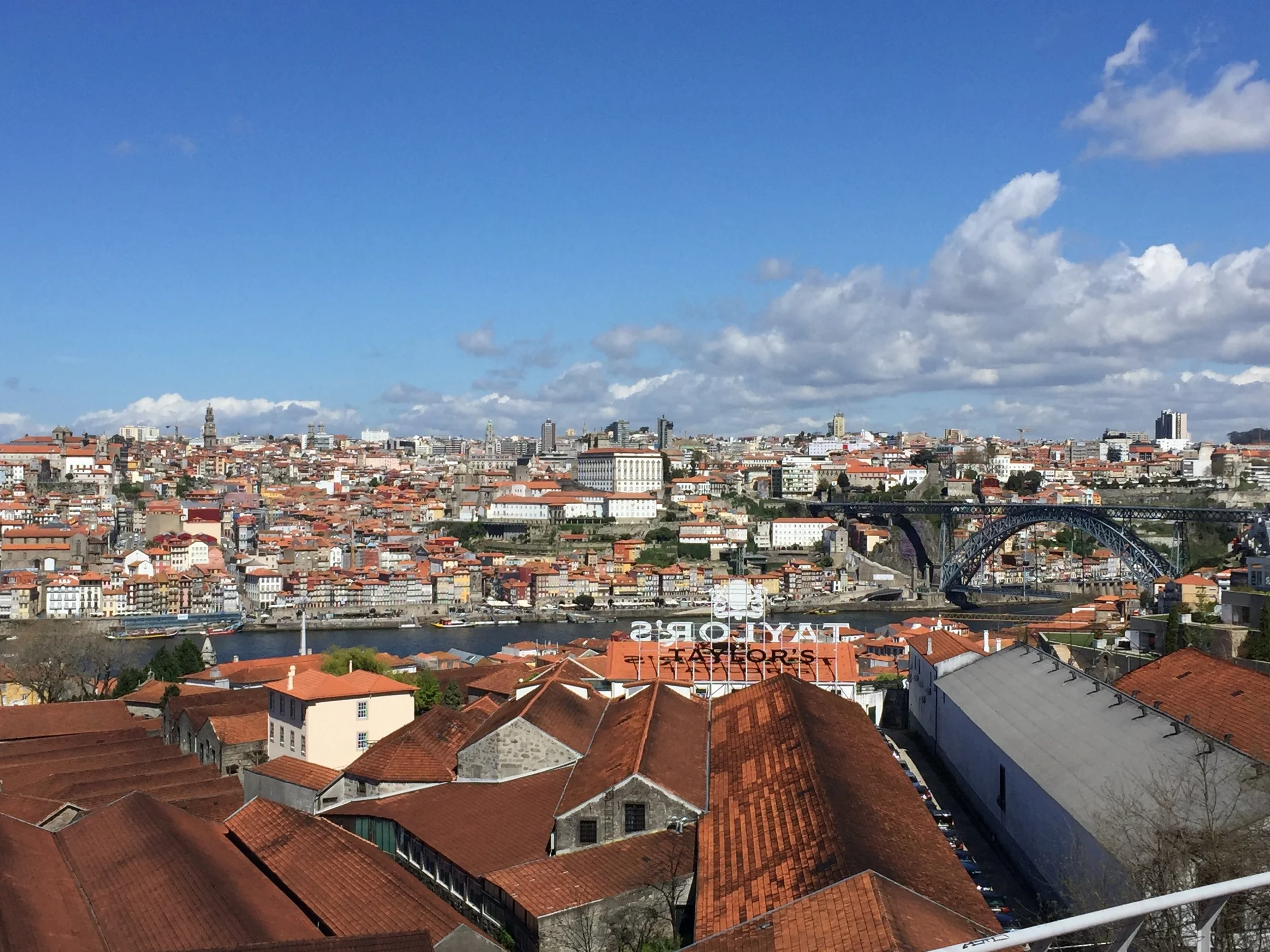 A view of the ancient city of Porto and the Dom Luis I bridge from the Gaia side (where they make all of the port, see the long roofs? Those are port distilleries.)