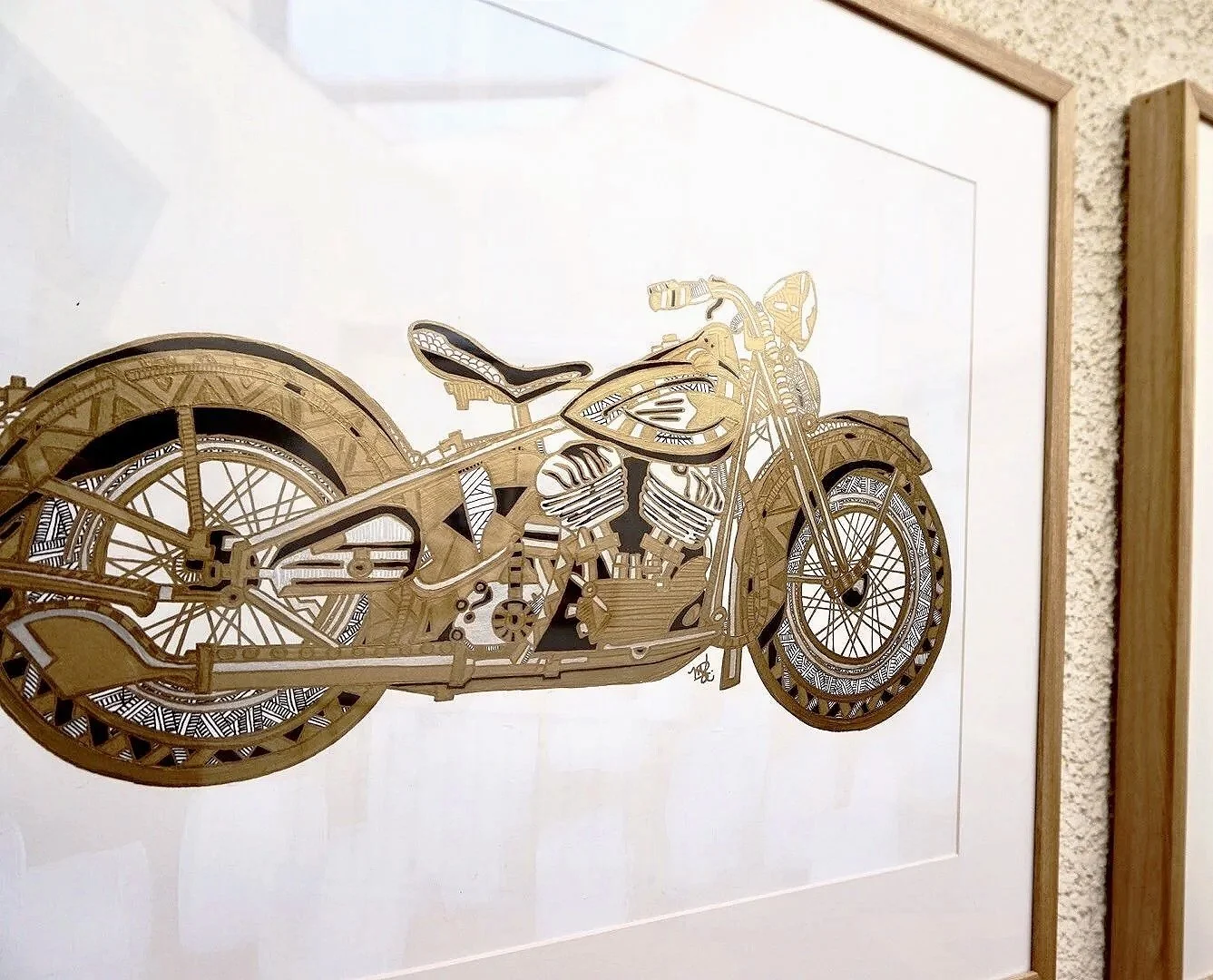 Wooden wall art of a motorcycle, framed on white background, displayed on a wall.