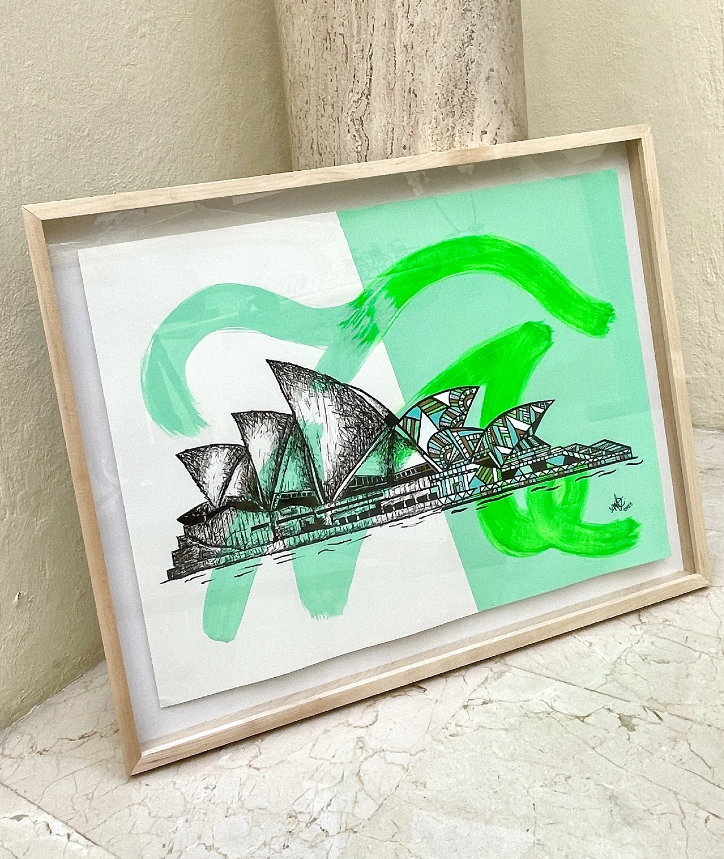 A framed artwork of the Sydney Opera House with green and turquoise abstract background brushstrokes.