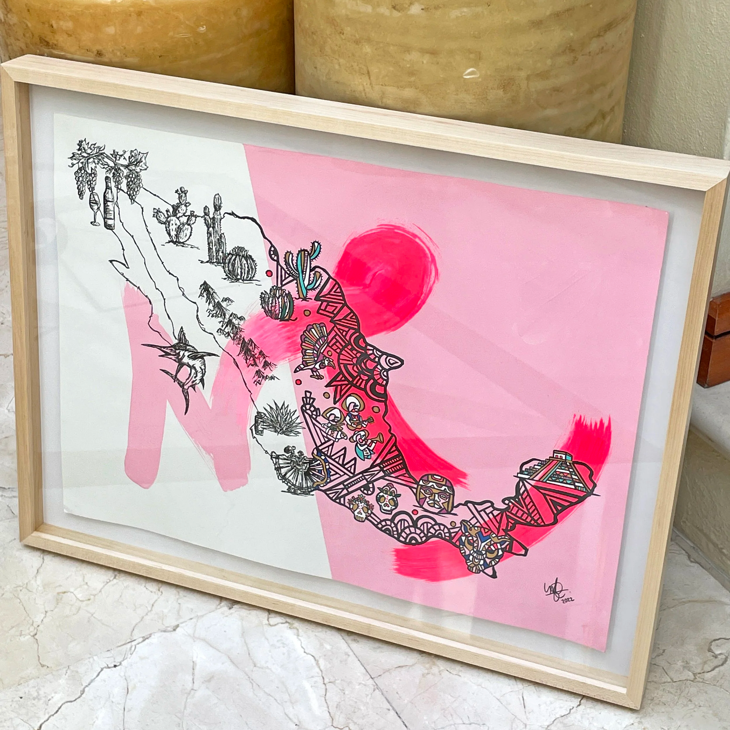 Framed artwork of a stylized map of Mexico with detailed black line drawings of symbols and landmarks on a pink background with a red sun.