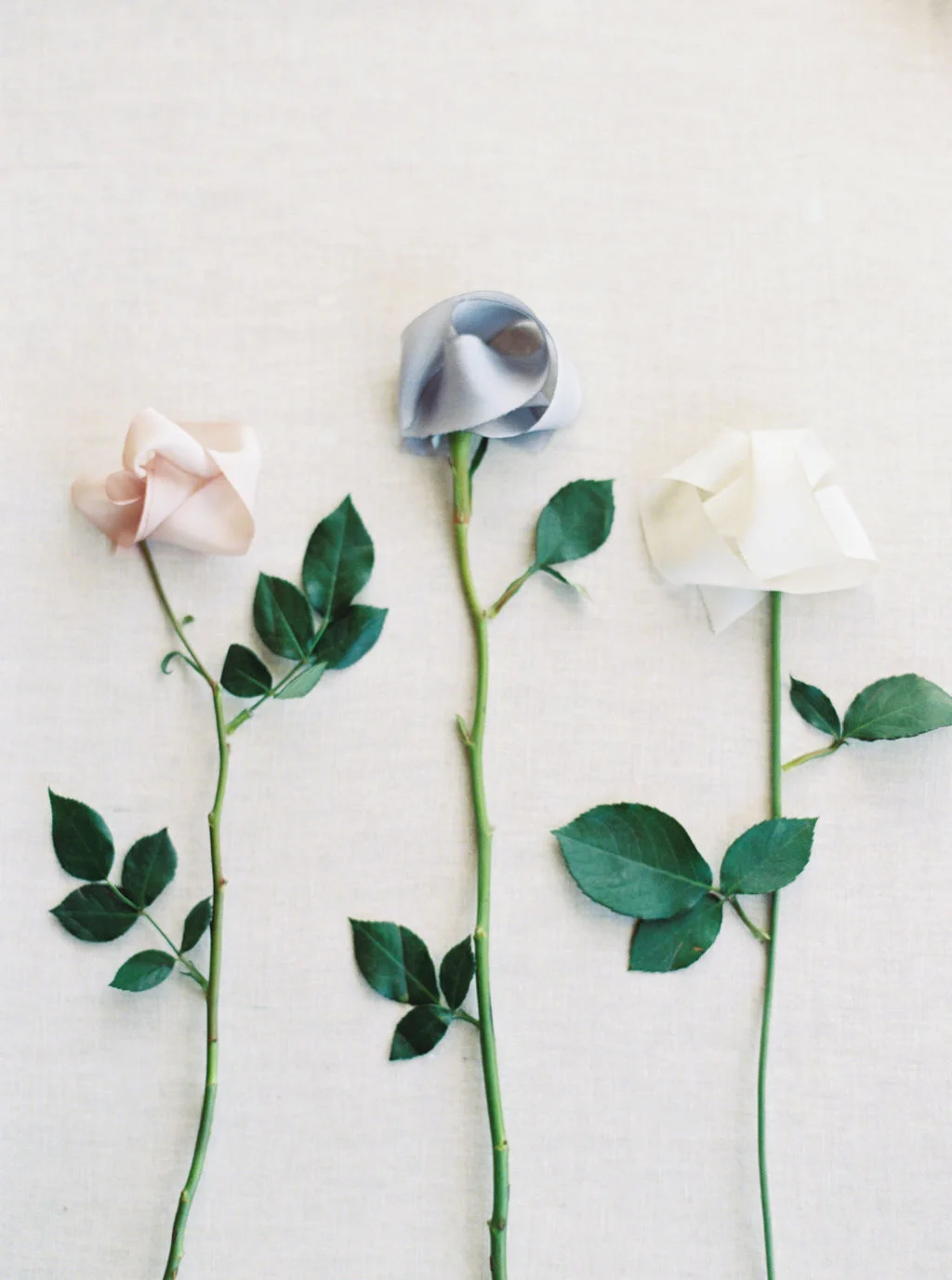 Blush, dusty blue, and antique white ribbons for Ciarra Claire wedding invitations.