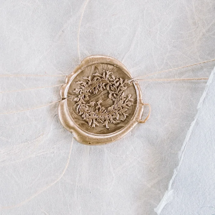 Ivy wreath wax seal in gold for wedding invitations.