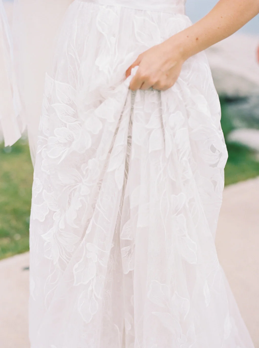Bride delicate tulle and lace wedding dress for a summer wedding.