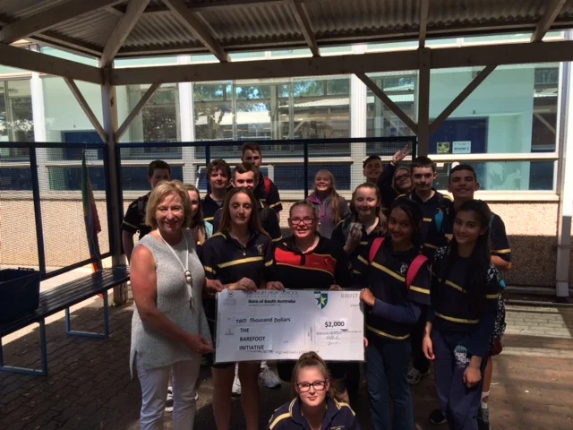 Year eight students presenting the $2500 raised by their incredible efforts