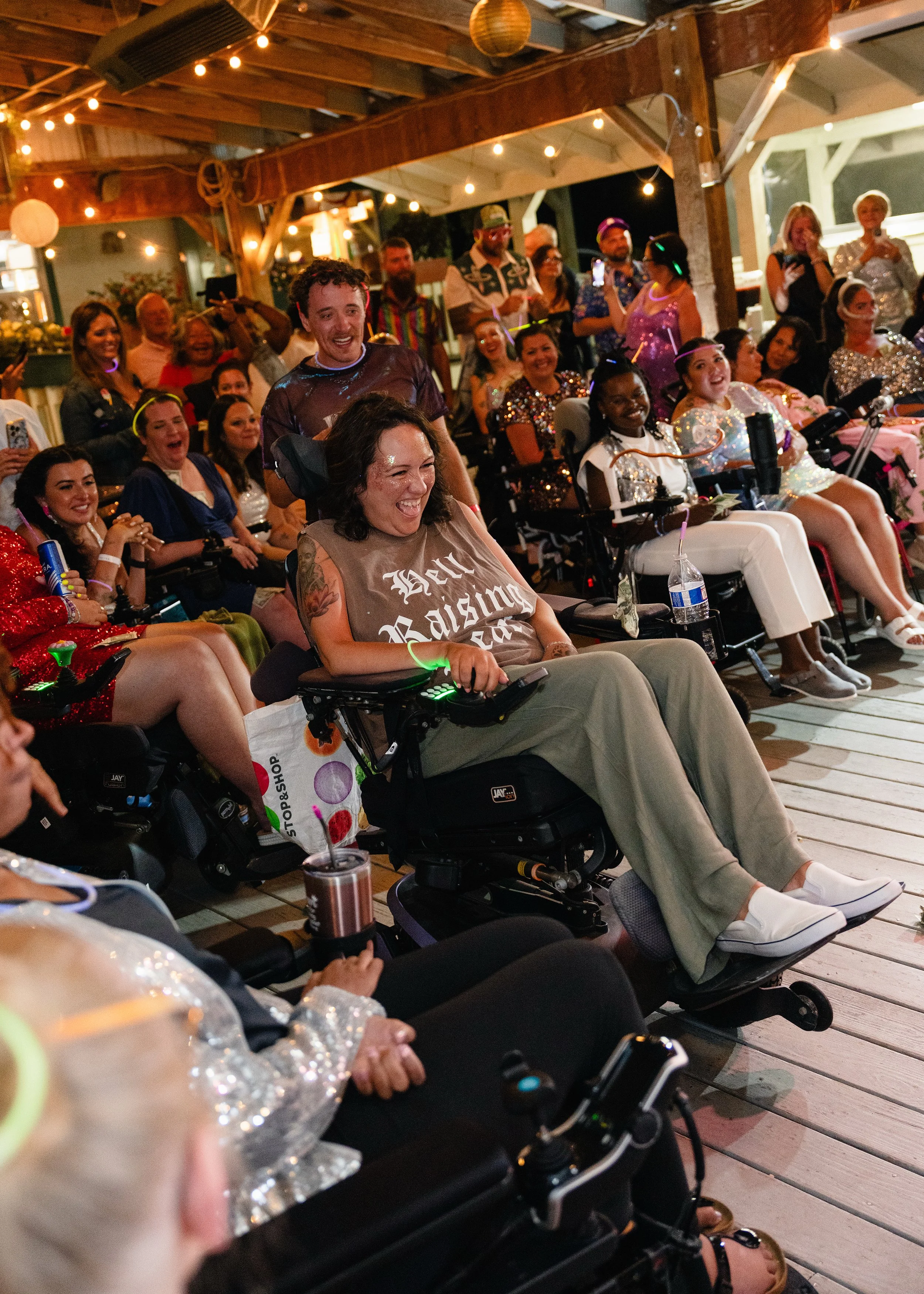 Attendees of the Her A.L.S. Story Retreat, including Jessica Northrop, dances during a drag show at Coonamessett Farm.