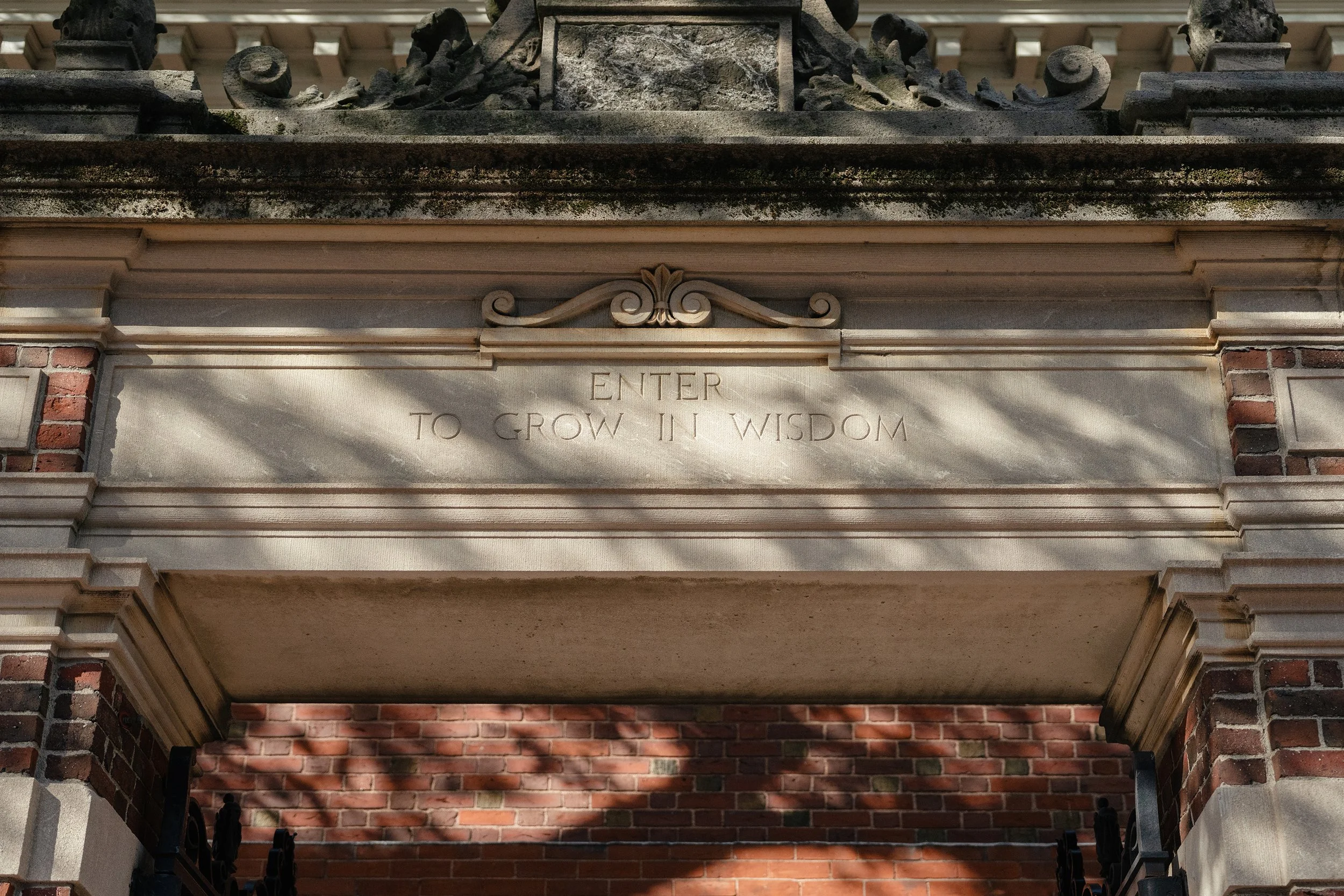 An inscription on a gate entering Harvard Yard.