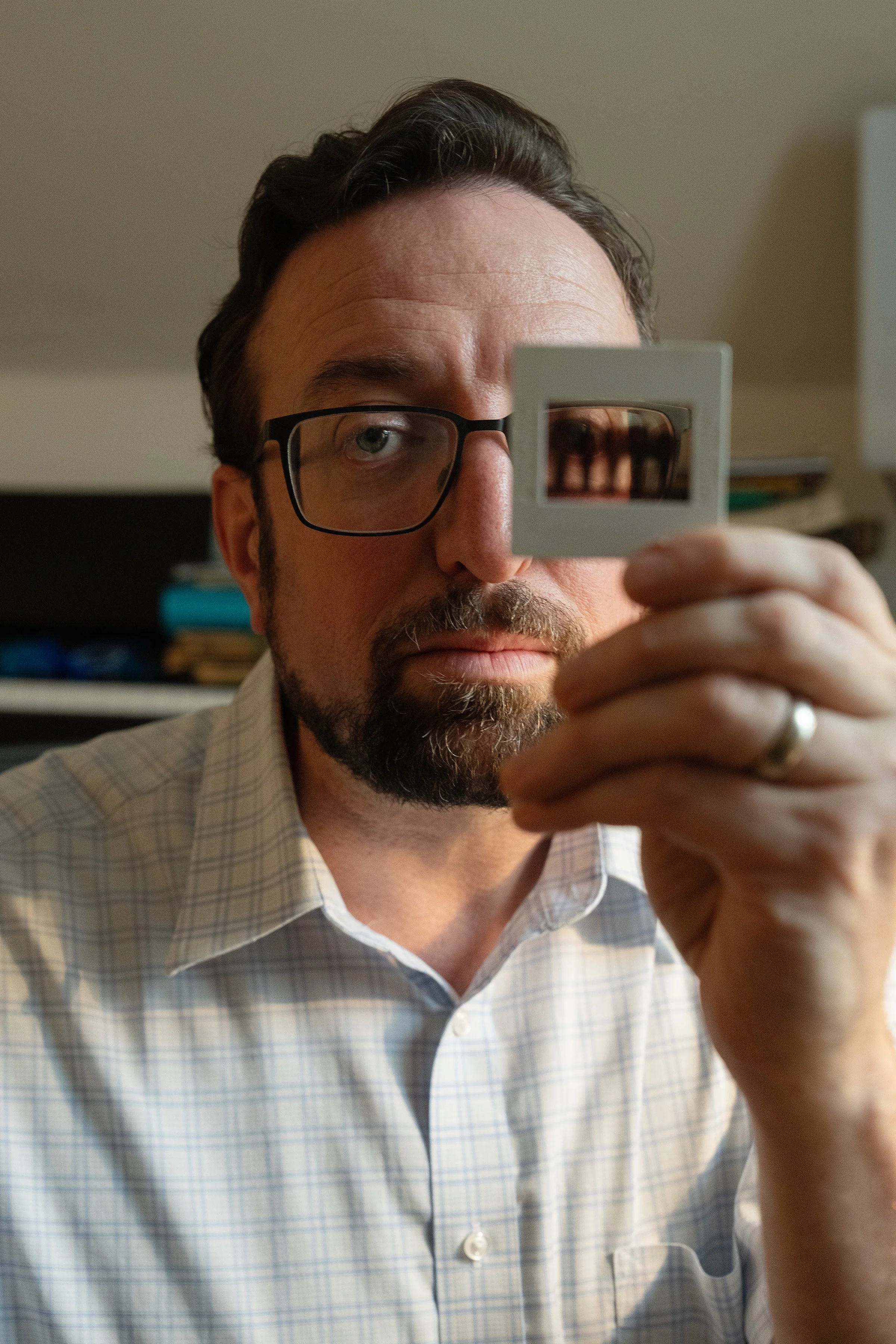 Alex Green poses for a portrait with a slide found on the grounds of the Walter E. Fernald State School after its closing.
