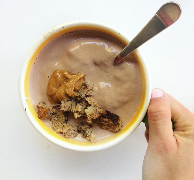 Juice plus chocolate powder with banana, peanut butter, milk, and ice topped with more peanut butter and banana bread crumbles.