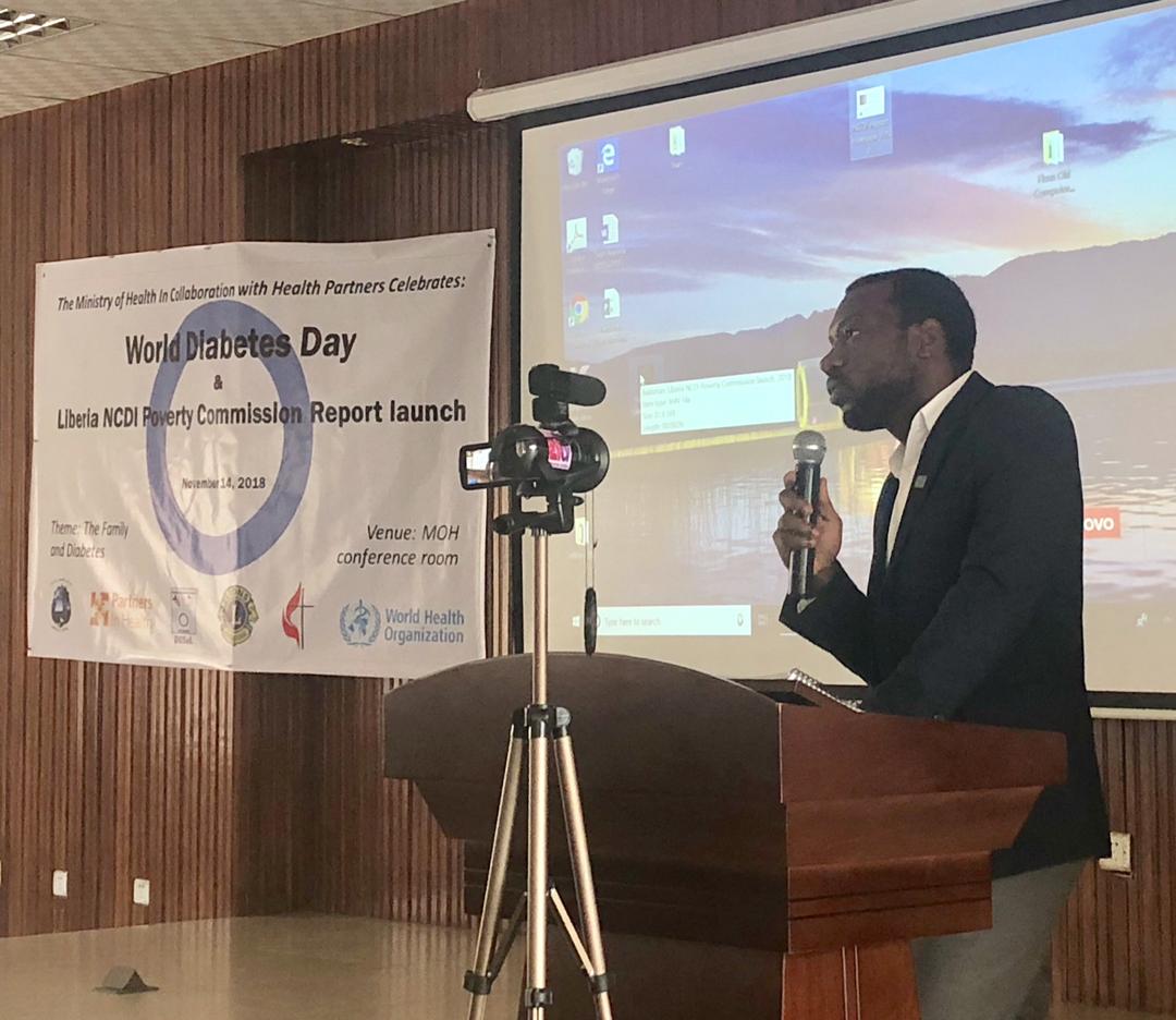 dr. fred amegashie, co-chair of the liberia ncdi poverty commission, presents key findings and recommendations at the official launch of the commission report.