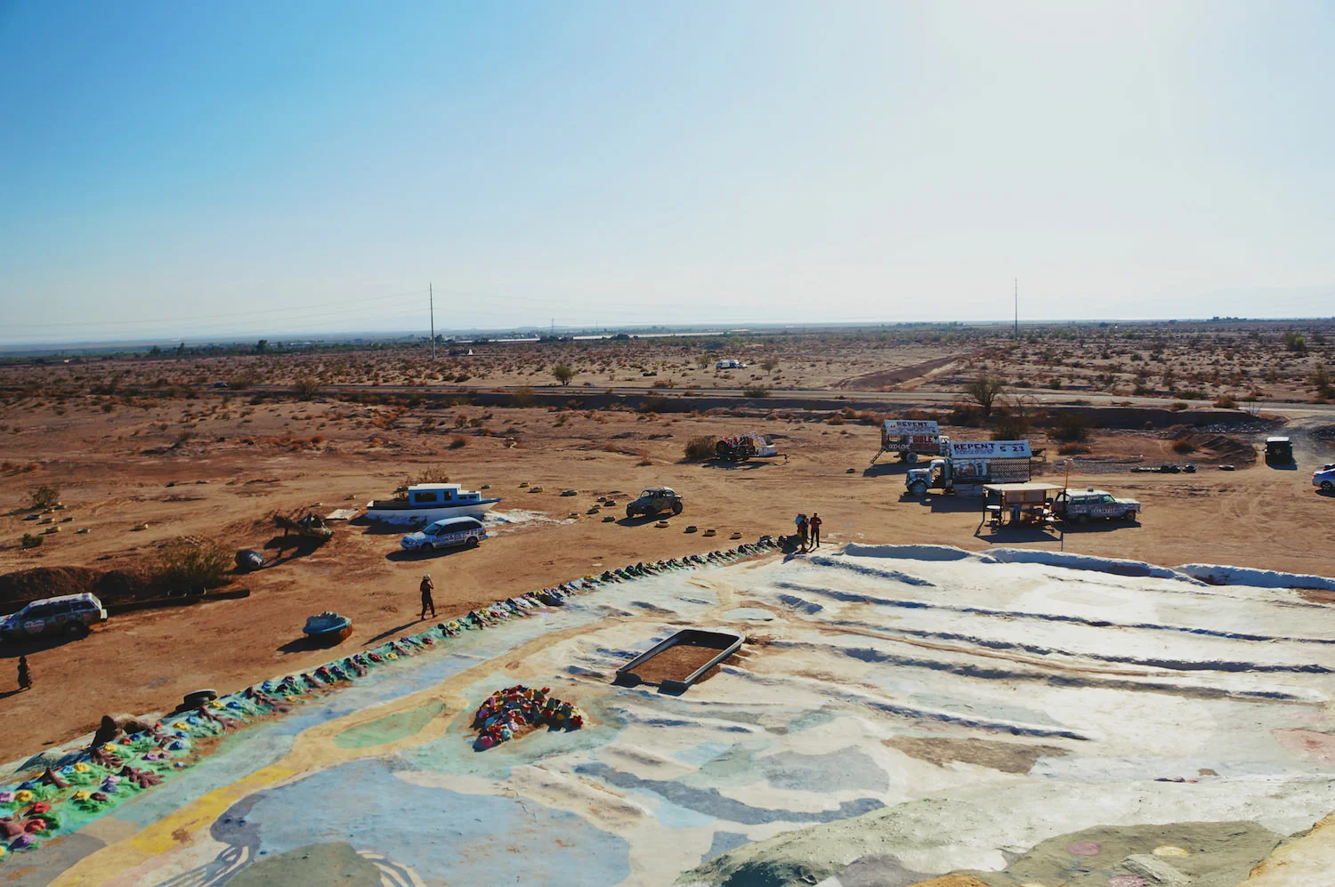 What is particularly breathtaking is the sight of this colourful, vibrant mountain, in the middle of the desert. This is the view from the front, from the back you see Slab City, a squatter-village of some 150 residents who live off zero fees and have zero rules, other than "live and let live". The land is owned by the state. You may have seen it in Sean Penn's Into the Wild.