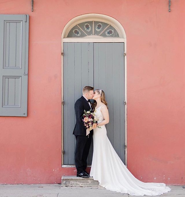 S + K lingering for kisses in this French Quarter doorway with her bridal bouquet in hand // planning: @vanessanoelevents photography: @annadelores
