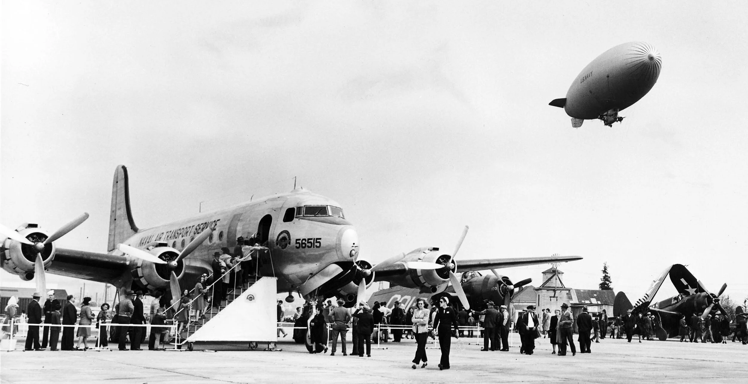 Air show with people lined up to look at planes, c. 1945