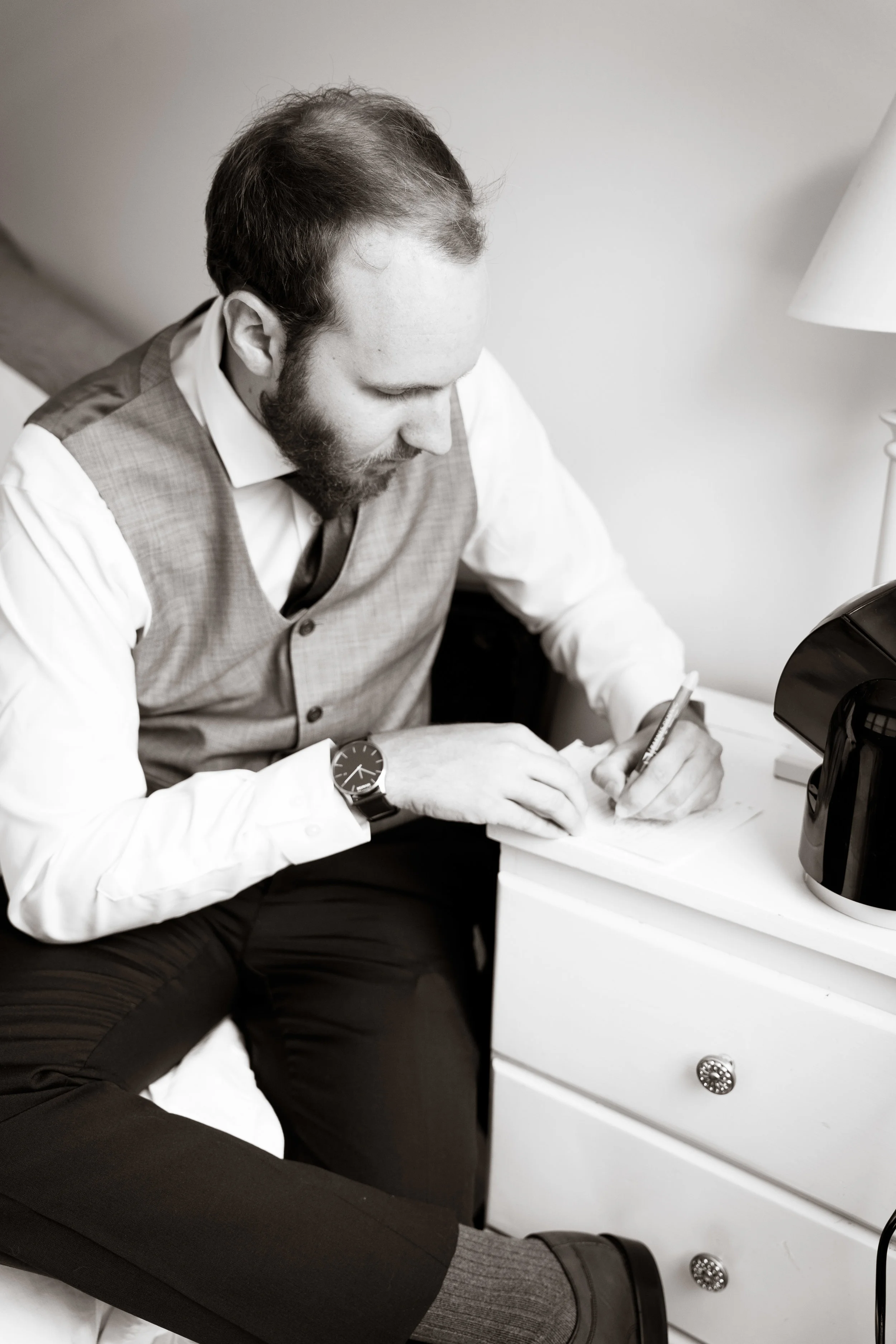 Groom writing note before ceremony, Downtown Greenville