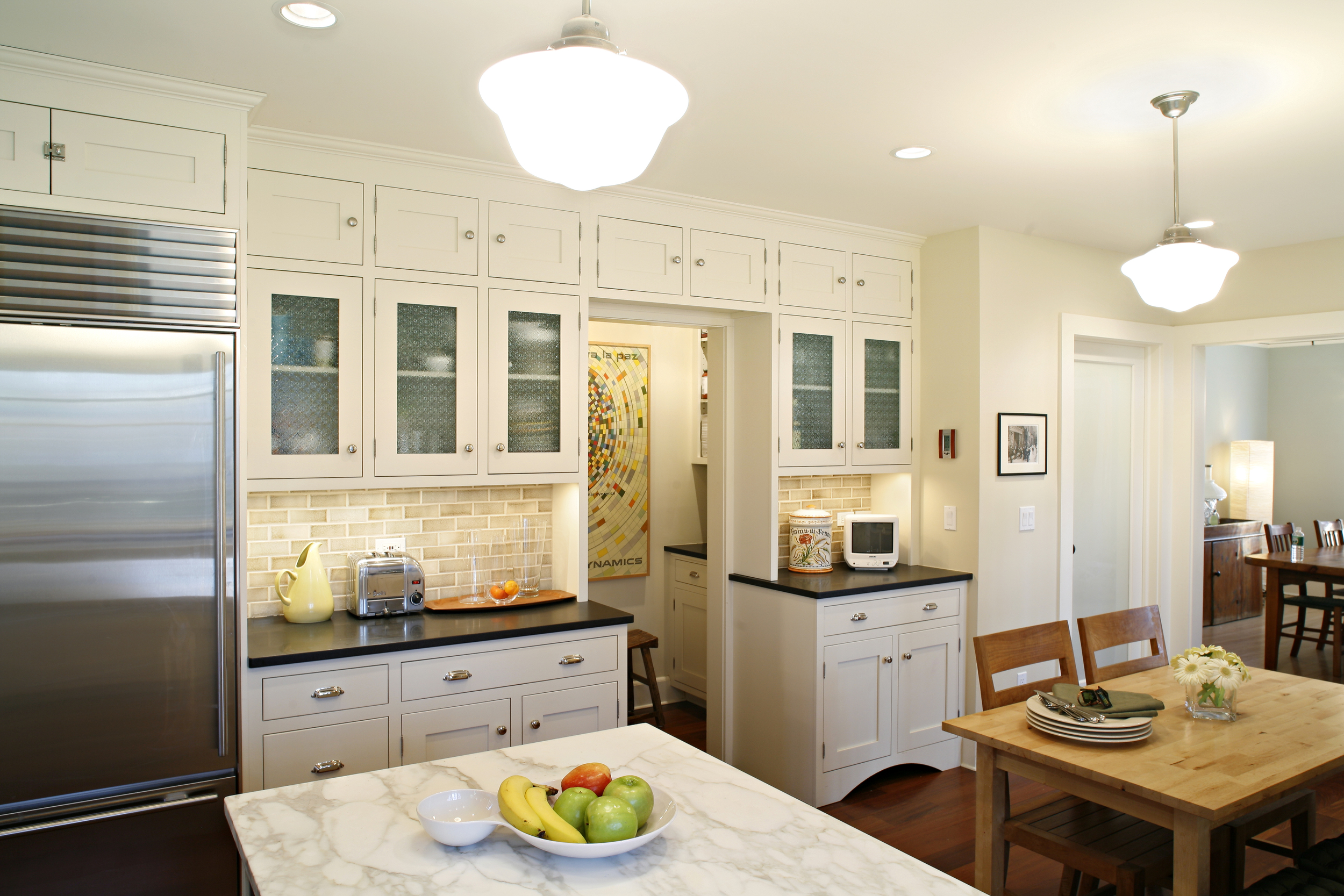 A 1920's side hall colonial renovation including kitchen, powder room, dining room, den and porch with eyebrow roof construction. Concept created and managed by Joanna Feldheim based on floor to ceiling cabinetry from the 1920's general stores. Architect: Rosette Komenian of RDK Architects. Construction: Stoddardt Associates