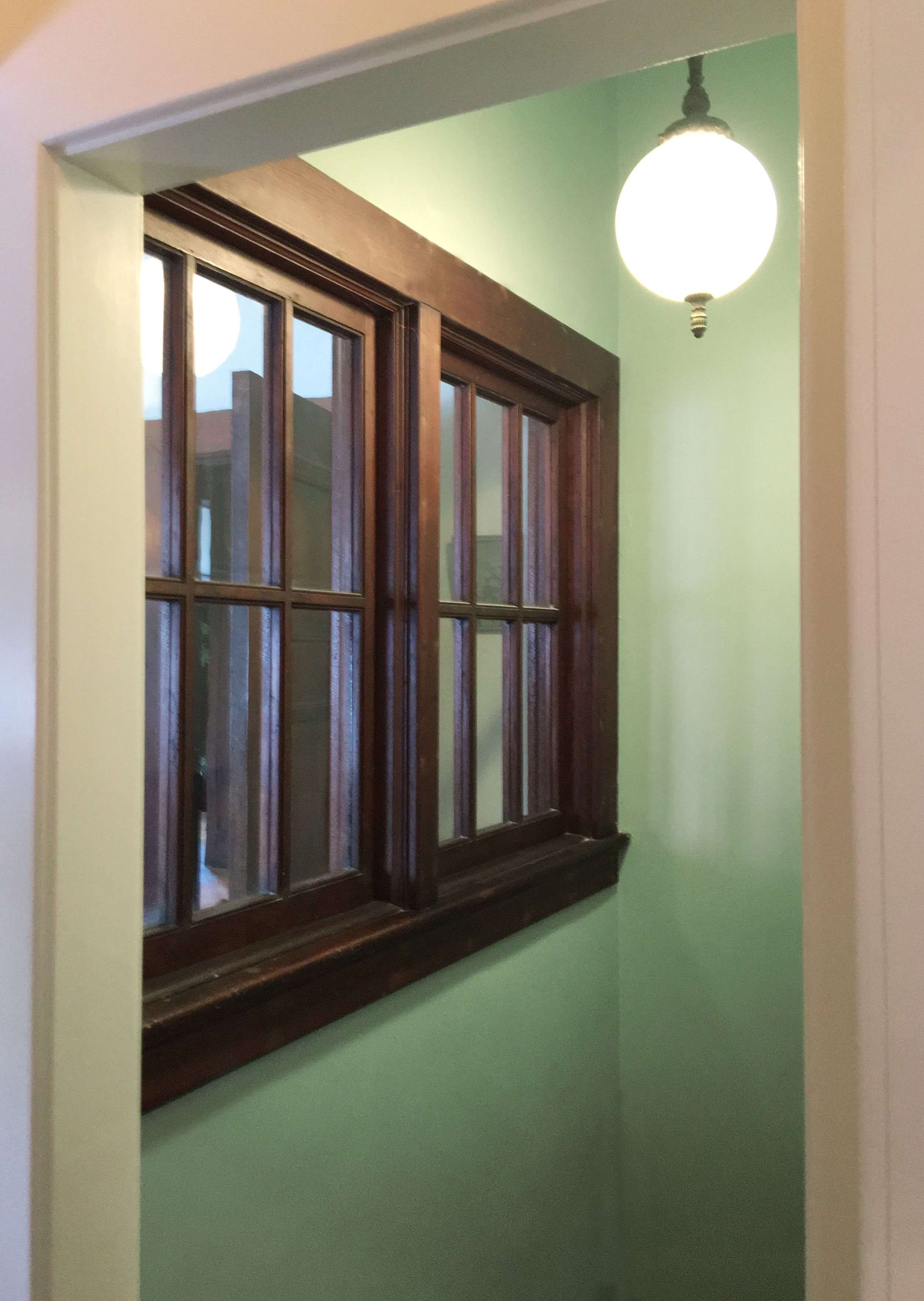 Basement stairwell brightened with a color researched from MadMen.