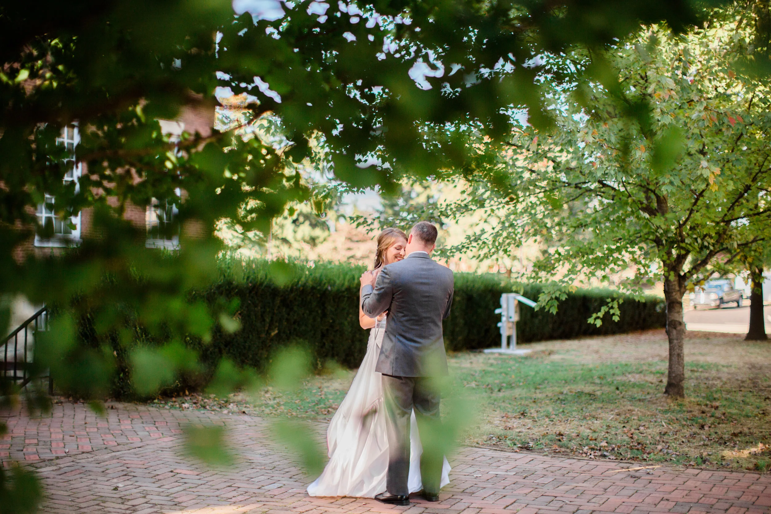 Bride and groom lovingly embrace and talk during first look