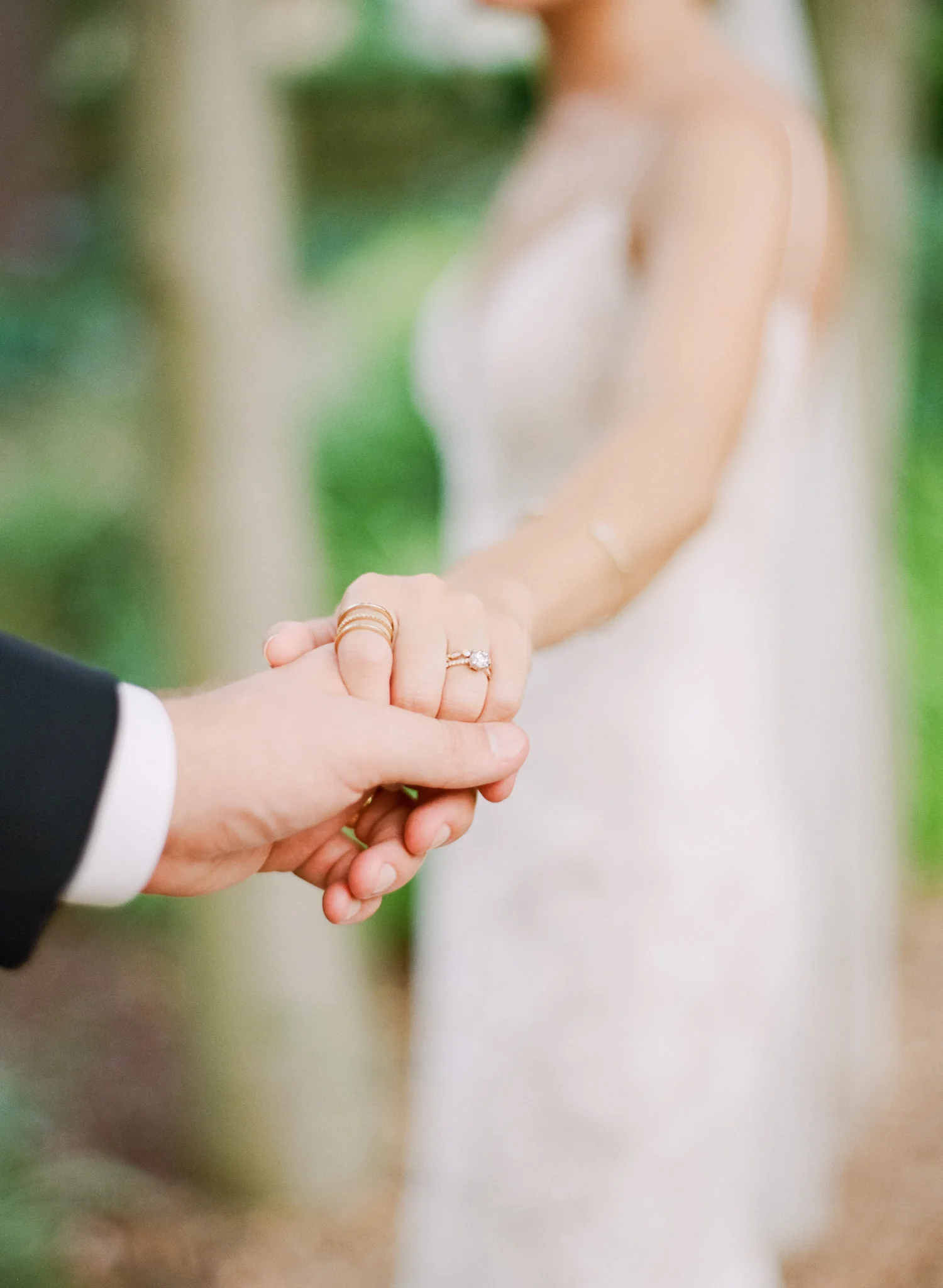 Image of bride wearing her ring holding the groom's hand taken with Contax 645 and 80mm f/2
